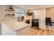 Bright kitchen featuring quartz countertops, white cabinetry, and stylish backsplash and flooring at 805 Northridge Rd, Highlands Ranch, CO 80126