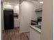 Bright kitchen features stainless steel appliances, white cabinets, and hardwood flooring, combining style and functionality at 805 Northridge Rd, Highlands Ranch, CO 80126