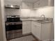 Efficient kitchen with stainless steel appliances, white cabinetry, and modern fixtures, perfect for cooking and entertaining at 805 Northridge Rd, Highlands Ranch, CO 80126