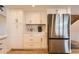 Bright kitchen with stainless steel refrigerator and sleek white cabinetry at 805 Northridge Rd, Highlands Ranch, CO 80126