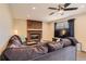 Inviting living room with a large sectional couch, brick fireplace, ceiling fan and neutral paint at 805 Northridge Rd, Highlands Ranch, CO 80126