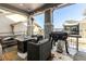 Cozy back patio with fire pit, seating, and grill at 997 Brocade Dr, Highlands Ranch, CO 80126