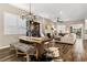 Open concept dining area with a live edge table and hardwood floors at 997 Brocade Dr, Highlands Ranch, CO 80126