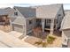 Charming single-Gathering home with attached garage and covered front porch with stone detail at 997 Brocade Dr, Highlands Ranch, CO 80126
