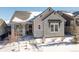 Beautiful two-story home with stone accents and a snowy front yard at 997 Brocade Dr, Highlands Ranch, CO 80126