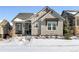 Charming craftsman style home with snowy landscaping at 997 Brocade Dr, Highlands Ranch, CO 80126