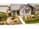 A view of the home's stone accents, tidy landscaping, and charming design at 997 Brocade Dr, Highlands Ranch, CO 80126