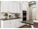 White kitchen cabinets, double oven, and quartz countertops at 997 Brocade Dr, Highlands Ranch, CO 80126