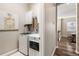Convenient laundry room with front-load washer and dryer, utility sink and storage cabinets at 997 Brocade Dr, Highlands Ranch, CO 80126