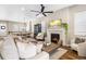 Bright living room with a fireplace and large windows at 997 Brocade Dr, Highlands Ranch, CO 80126