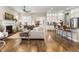 Open concept living room with kitchen and hardwood floors at 997 Brocade Dr, Highlands Ranch, CO 80126