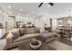 Open concept living room with sectional sofa and hardwood floors at 997 Brocade Dr, Highlands Ranch, CO 80126