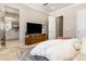 Main bedroom with ensuite bathroom and a flat screen TV at 997 Brocade Dr, Highlands Ranch, CO 80126