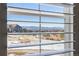 Enjoy this picturesque view from the window of snowy fields, neighborhood rooftops, and distant mountains at 997 Brocade Dr, Highlands Ranch, CO 80126
