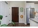Welcoming entryway with a view into the modern kitchen and stainless steel refrigerator at 2729 W 28Th Ave # 302, Denver, CO 80211