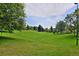 Serene park featuring lush green grass and mature trees creating a peaceful environment at 2729 W 28Th Ave # 302, Denver, CO 80211