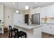 Modern kitchen featuring stainless steel appliances, white cabinetry, and a spacious island with bar seating at 2729 W 28Th Ave # 302, Denver, CO 80211