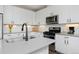Bright kitchen featuring white cabinetry, stainless steel appliances, and quartz countertops at 2729 W 28Th Ave # 302, Denver, CO 80211