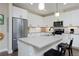 Bright kitchen with white cabinets, stainless steel appliances, and a central island with seating at 2729 W 28Th Ave # 302, Denver, CO 80211