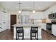 Modern kitchen with sleek white cabinets, stainless steel appliances, and a spacious center island at 2729 W 28Th Ave # 302, Denver, CO 80211