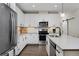 Well-equipped kitchen with stainless steel appliances, a center island, and subway tile backsplash at 2729 W 28Th Ave # 302, Denver, CO 80211