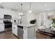 Open-concept living space with a modern kitchen and a comfortable living area with outdoor access at 2729 W 28Th Ave # 302, Denver, CO 80211