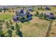 Aerial view of a home with a spacious backyard, patio, and lush greenery in a serene neighborhood at 2351 Sagebrush St, Parker, CO 80138