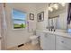 Bathroom with a vanity, toilet, framed art, modern fixtures and natural light at 2351 Sagebrush St, Parker, CO 80138