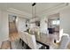 Open-concept dining area with a large table, stylish chairs, and views into other living spaces at 2351 Sagebrush St, Parker, CO 80138