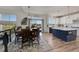 Bright dining area with modern chandelier, leading to the spacious kitchen with a large island at 2351 Sagebrush St, Parker, CO 80138