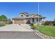 Charming two-story home with a manicured lawn, stone accents, and a welcoming front porch at 2351 Sagebrush St, Parker, CO 80138