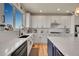 Well-lit kitchen with stainless steel appliances, white cabinetry, and a large picture window at 2351 Sagebrush St, Parker, CO 80138