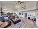 Open concept living room with vaulted ceilings, hardwood floors, and black iron railing at 2351 Sagebrush St, Parker, CO 80138