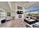 Spacious living room featuring high ceilings, large windows, a fireplace, and comfortable seating at 2351 Sagebrush St, Parker, CO 80138