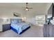 Spacious main bedroom featuring a tray ceiling, plush carpet, and a view of the second-story landing at 2351 Sagebrush St, Parker, CO 80138