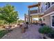 Inviting outdoor living space with a stone patio, multiple seating areas, and beautiful landscaping at 2351 Sagebrush St, Parker, CO 80138