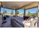 Covered patio with lounge seating, hot tub, and outdoor views of the open space at 2351 Sagebrush St, Parker, CO 80138