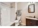 Bathroom features a shower, stylish vanity with granite countertop, updated fixtures and decorative wall mirror at 4885 S Algonquian Way, Aurora, CO 80016