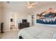 A relaxing bedroom with a ceiling fan, neutral carpet flooring, and a modern tapestry at 4885 S Algonquian Way, Aurora, CO 80016