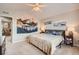 Bright bedroom featuring neutral carpet, ceiling fan and two wall decor accent paintings at 4885 S Algonquian Way, Aurora, CO 80016