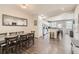 Open-concept dining room with dark wood floors flowing into the adjacent kitchen and living areas at 4885 S Algonquian Way, Aurora, CO 80016