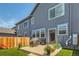 Home's exterior features a well-maintained lawn, garden beds, and an outdoor covered grill on a concrete patio at 4885 S Algonquian Way, Aurora, CO 80016