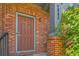 Close-up of the front door, showcasing the brick facade and address number of the townhome at 4885 S Algonquian Way, Aurora, CO 80016