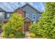 Charming townhome featuring a brick facade, gray siding, and well-maintained landscaping at 4885 S Algonquian Way, Aurora, CO 80016