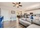 Comfortable living room with an open layout, wood floors, and seamless connection to the kitchen and dining area at 4885 S Algonquian Way, Aurora, CO 80016