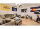 Relaxing living room with a plush sectional sofa, entertainment center, and wood flooring at 4885 S Algonquian Way, Aurora, CO 80016