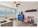 Cozy living area with wood floors, a comfortable sofa, and a bright window for natural light at 4885 S Algonquian Way, Aurora, CO 80016