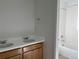 Bathroom showcasing double sinks, white countertops, wooden cabinetry, and a tiled shower/tub combo at 2025 Barnwood Dr, Brighton, CO 80601