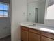 Bathroom with wood vanity, quartz countertop, and a view of a window looking outdoors at 2025 Barnwood Dr, Brighton, CO 80601