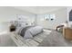 Main bedroom with light walls, large bed and cozy armchair at 2025 Barnwood Dr, Brighton, CO 80601